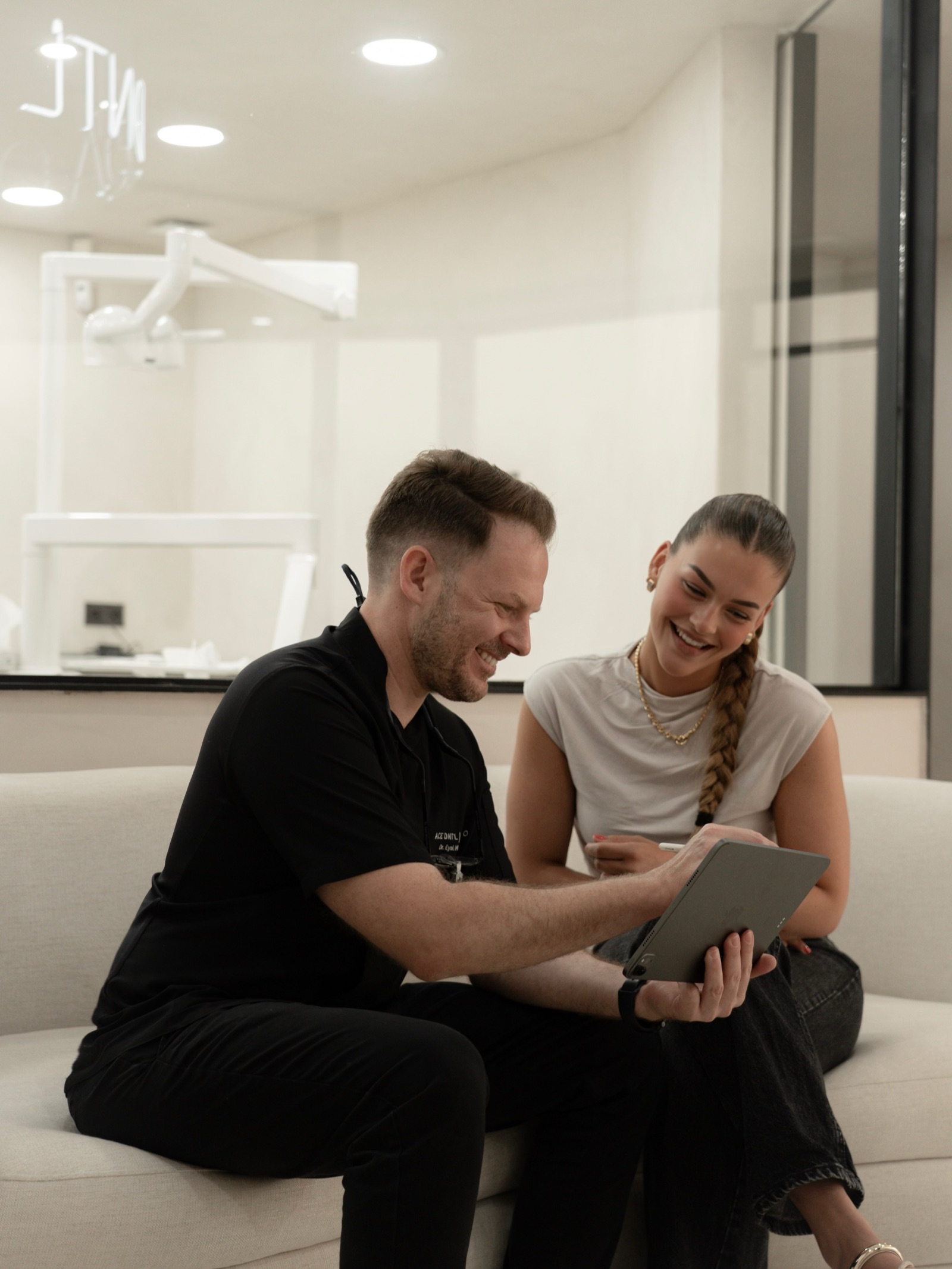 A consultation at ACE DNTL STUDIO — reviewing the treatment plan together on a tablet